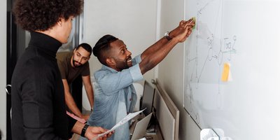 Team planning at a whiteboard (Pexels 5257576)