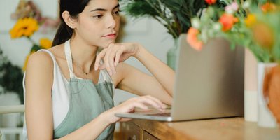 Florist at a laptop in her shop (Pexels 5410143)