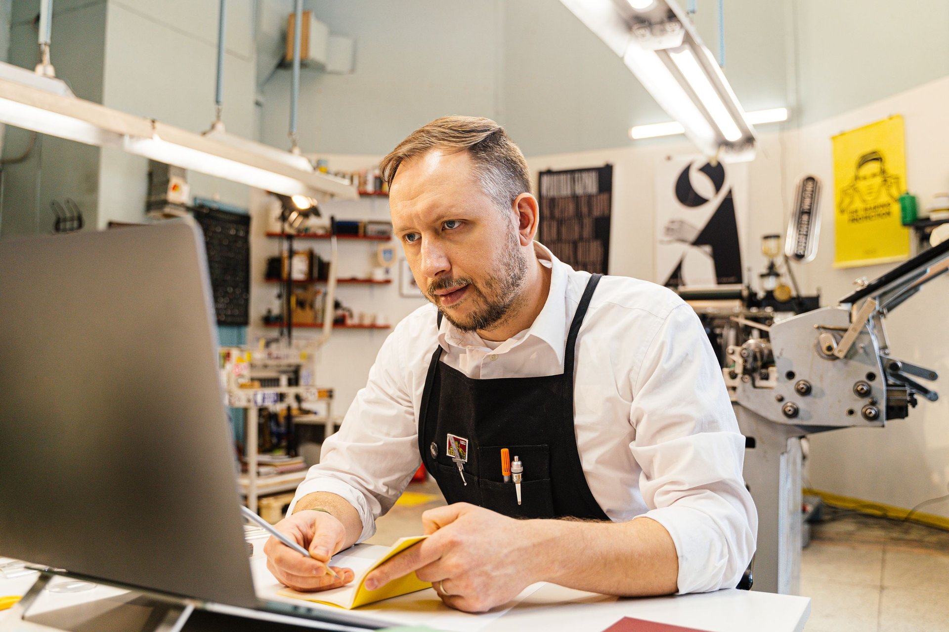 Print shop owner at a laptop (Pexels 6621020)